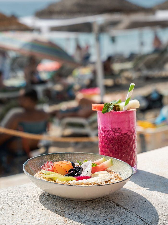 A smoothie bowl in front of the parasols.
