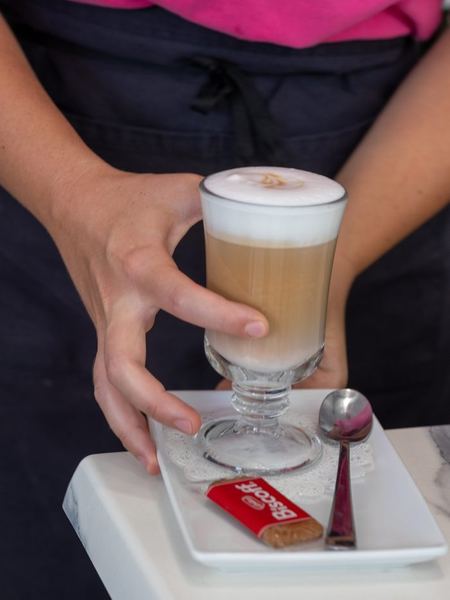 A layered latte in a tall glass.