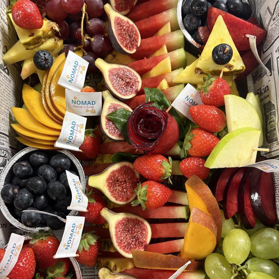 A grazing table of fruit, cheese and charcuterie by Café Nomad.