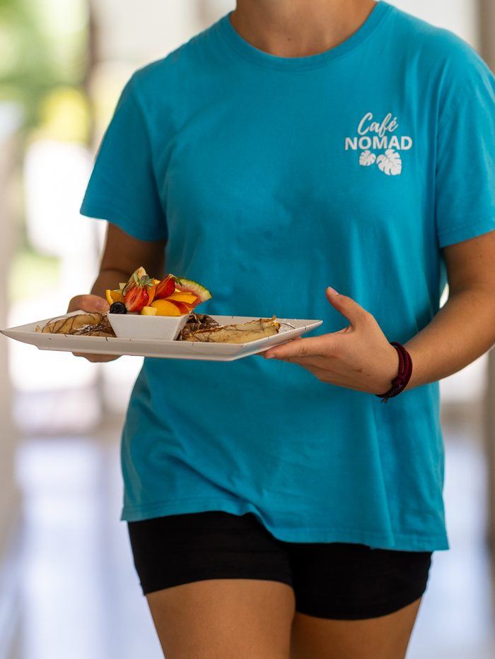 A server bringing a brunch plate.